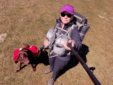 Christine takes a selfie with her dog, Gino, at the start of her hike along the England Coast Path.